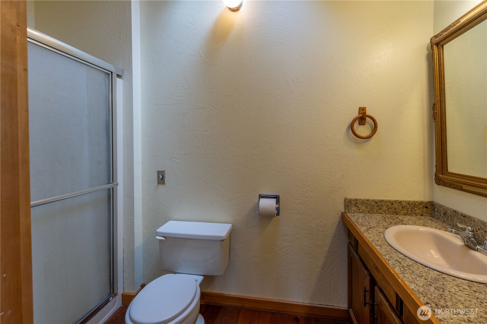 182 Sunset Place Sequim, WA 98382 - Photo 14 of 18 a bathroom with a granite countertop toilet a sink and a mirror
