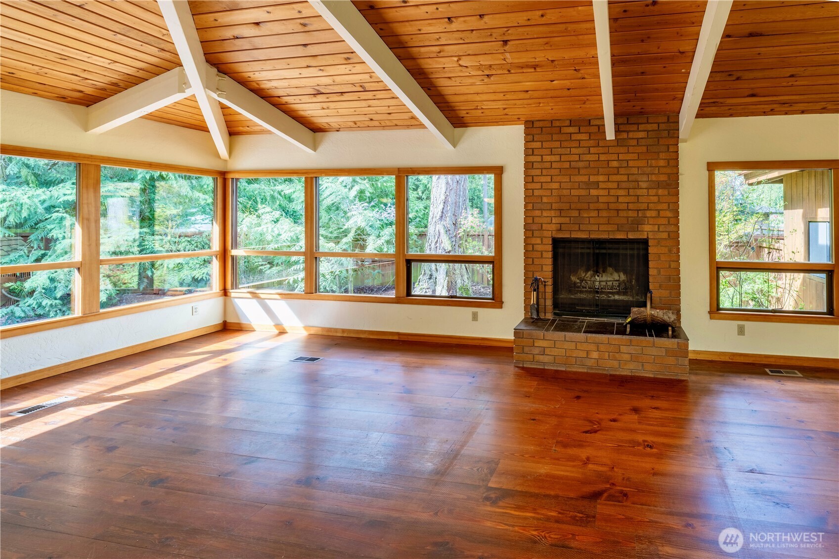 182 Sunset Place Sequim, WA 98382 - Photo 7 of 18 a view of empty room with wooden floor and fireplace