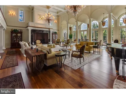 a living room with fireplace furniture and a wooden floor