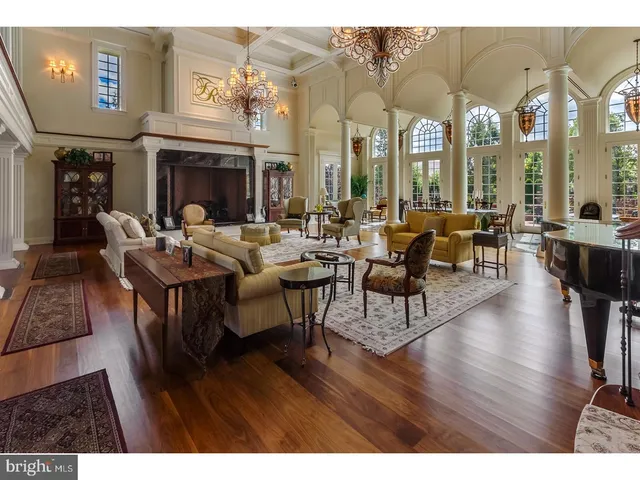 a living room with fireplace furniture and a wooden floor