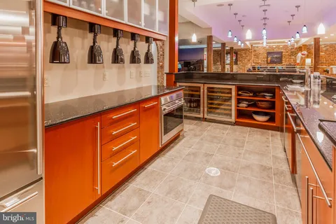 a large kitchen with stainless steel appliances kitchen island granite countertop a large kitchen counter top and oven