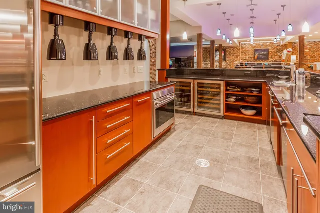 a large kitchen with stainless steel appliances kitchen island granite countertop a large kitchen counter top and oven