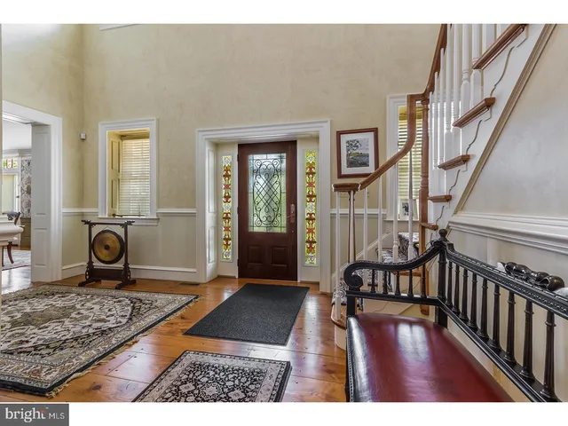 a view of an entryway with wooden floor