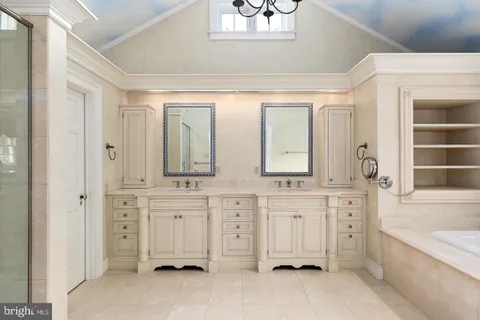 a bathroom with a granite countertop sink and a large mirror