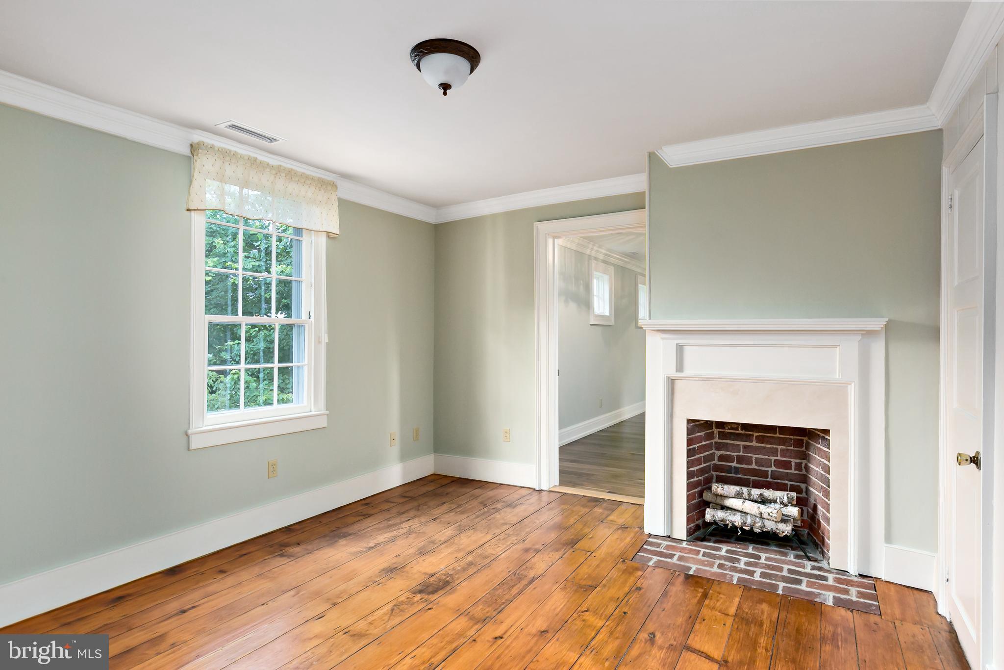 628 Windsock Way Moorestown, NJ 08057 - Photo 30 of 50 an empty room with wooden floor a fireplace and windows