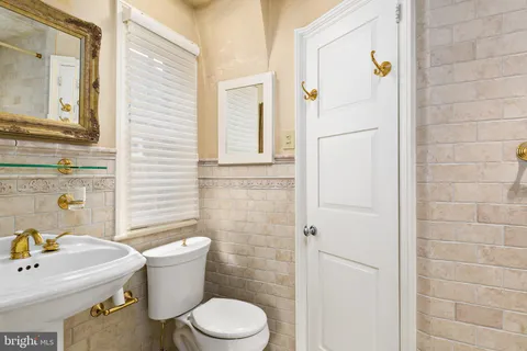 a bathroom with a toilet a sink and shower