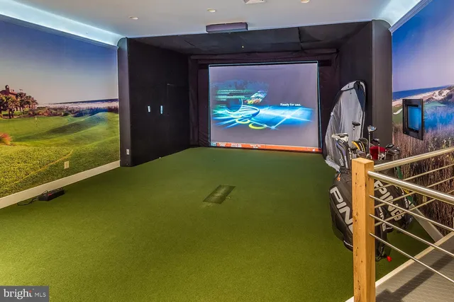 a living room with furniture a rug and paintings on the wall