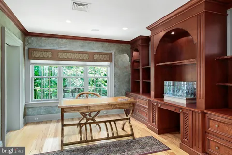 a dining room with furniture and a large window