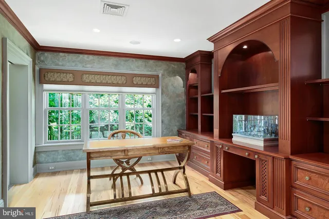 a dining room with furniture and a large window