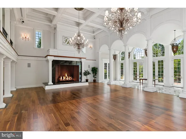 a view of a livingroom with fireplace and wooden floor