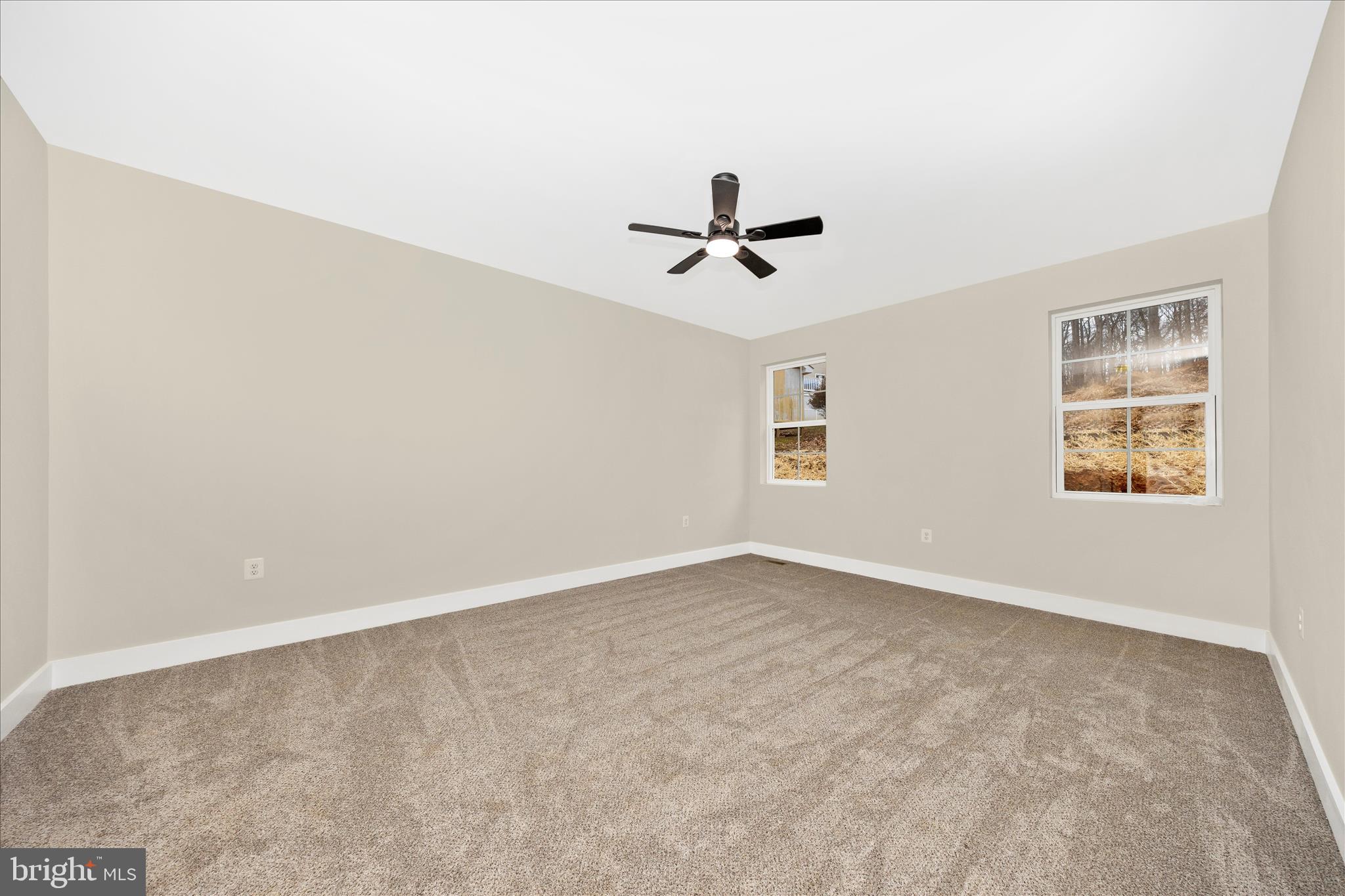 7816 Fairplay Road Fairplay, MD 21733 - Photo 13 of 34 an empty room with a window and a ceiling fan