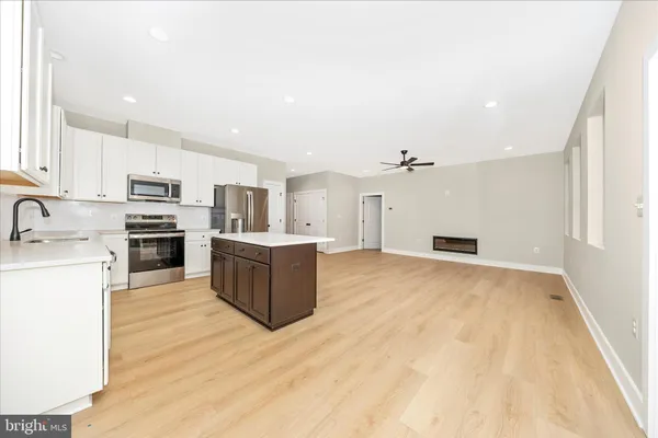 a view of kitchen with granite countertop cabinets and wooden floor
