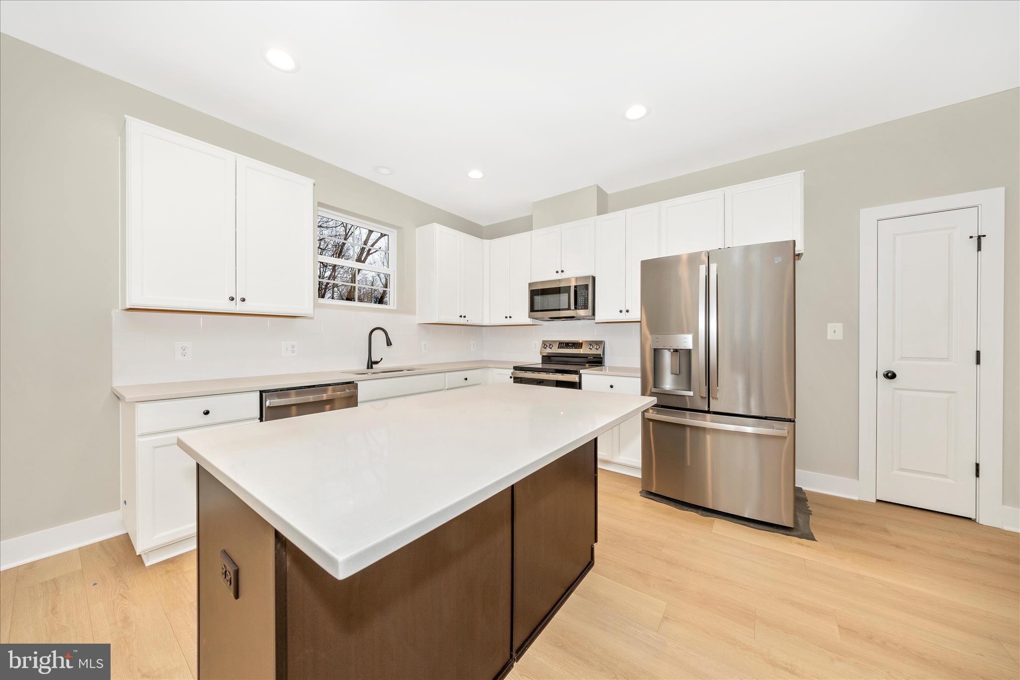 7816 Fairplay Road Fairplay, MD 21733 - Photo 31 of 34 a kitchen with a refrigerator a stove a microwave and a refrigerator