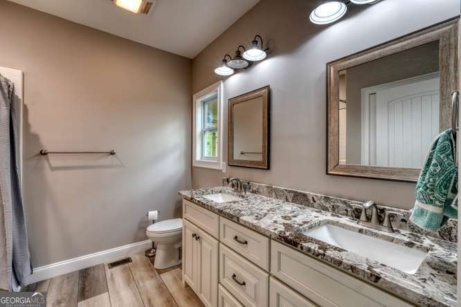 478 Flat Top Road, Unit 6 Young Harris, GA 30582 - Photo 27 of 70 a bathroom with a granite countertop sink mirror and toilet