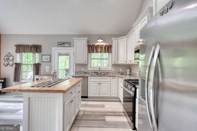 478 Flat Top Road, Unit 6 Young Harris, GA 30582 - Photo 47 of 70 a kitchen with stainless steel appliances granite countertop a sink stove and refrigerator