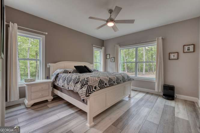 478 Flat Top Road, Unit 6 Young Harris, GA 30582 - Photo 5 of 70 a bedroom with a large bed wooden floor and windows
