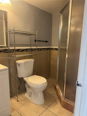 a bathroom with a toilet and a shower