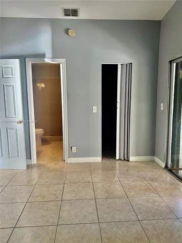 a view of a livingroom with an empty space and closet area