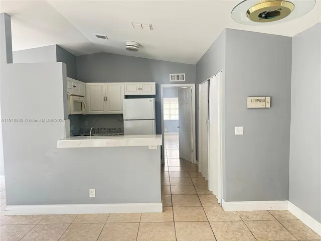 a kitchen with stainless steel appliances a refrigerator and a stove