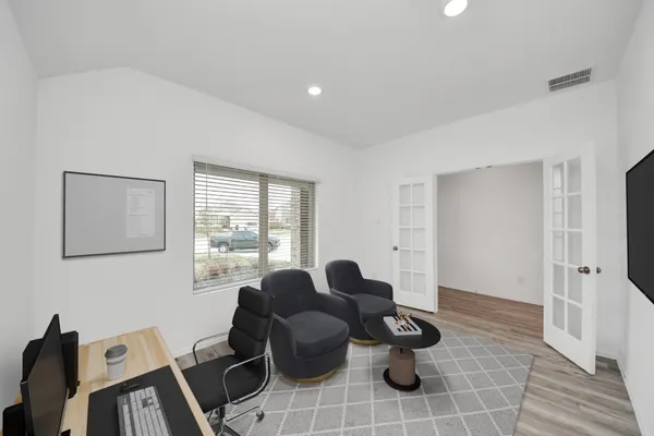 a living room with furniture and wooden floor