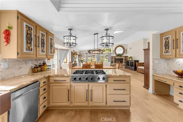 a kitchen with stainless steel appliances granite countertop a stove and cabinets