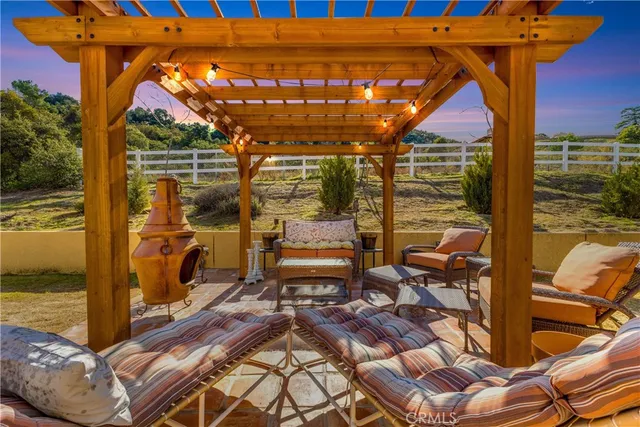 a view of a patio with table and chairs under an umbrella