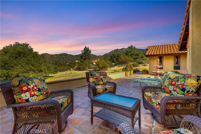 a view of a chairs and table in patio