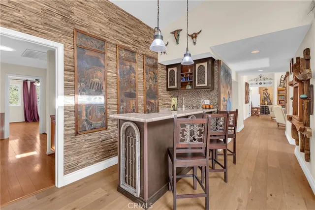 a view of a dining room with furniture and a chandelier