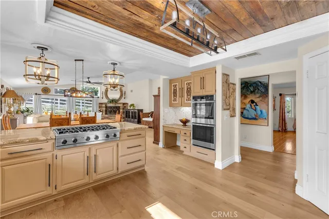 a kitchen with stainless steel appliances granite countertop a stove and cabinets