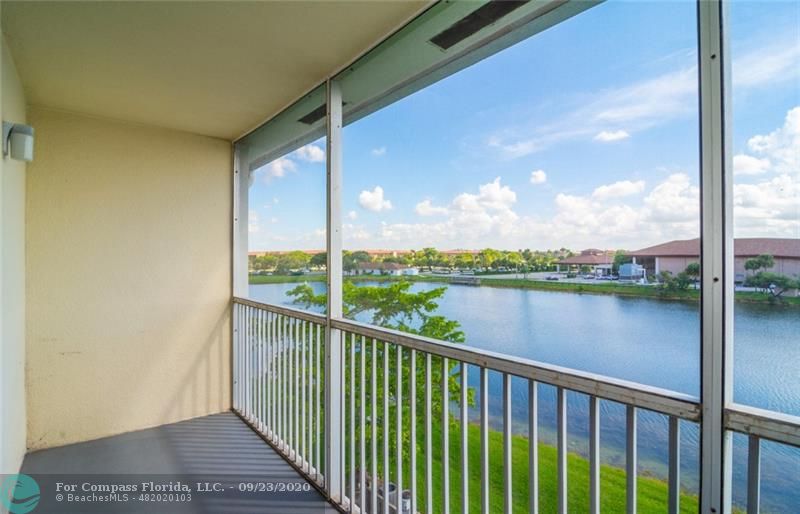 Enjoy coffee from your screened balcony  (freshly painted floor) with amazing wide lake views.  Community Clubhouse in the background.