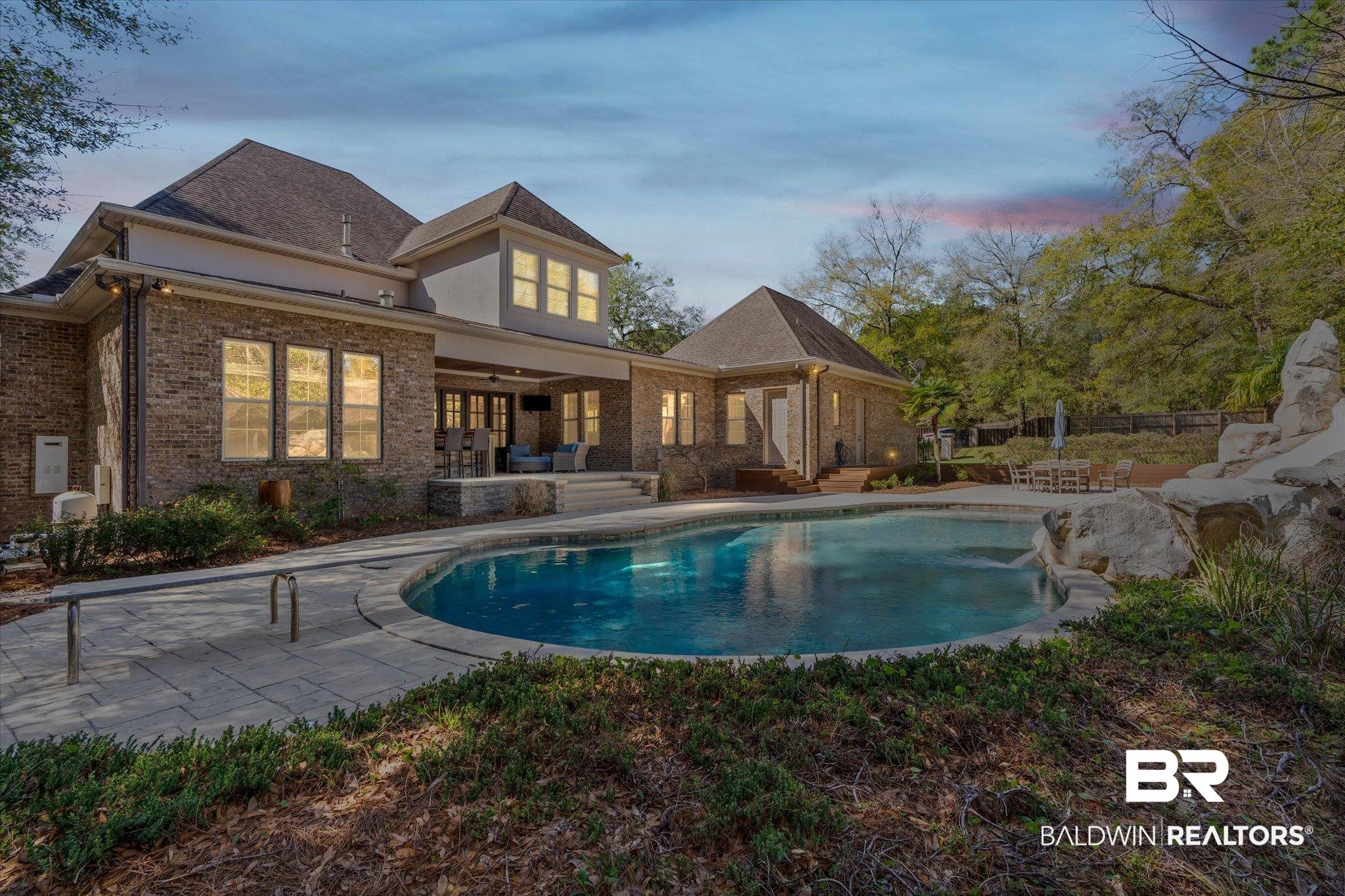7676 Rockstone Lane Mobile, AL 36695 - Photo 2 of 47 Back of house featuring a patio area, an outdoor pool, and brick siding