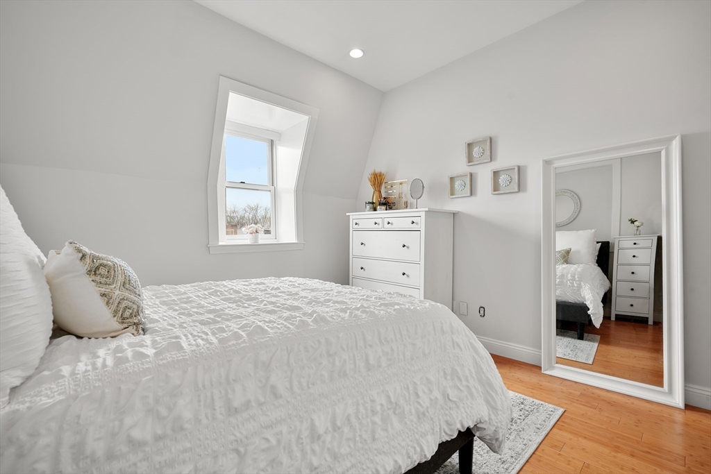 21 Worcester Square, Unit 5 Boston, MA 02118 - Photo 21 of 33 a bedroom with a bed and wooden floor