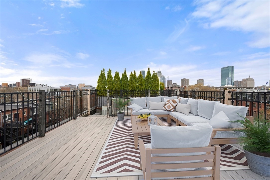 21 Worcester Square, Unit 5 Boston, MA 02118 - Photo 27 of 33 a roof deck with couches and wooden floor