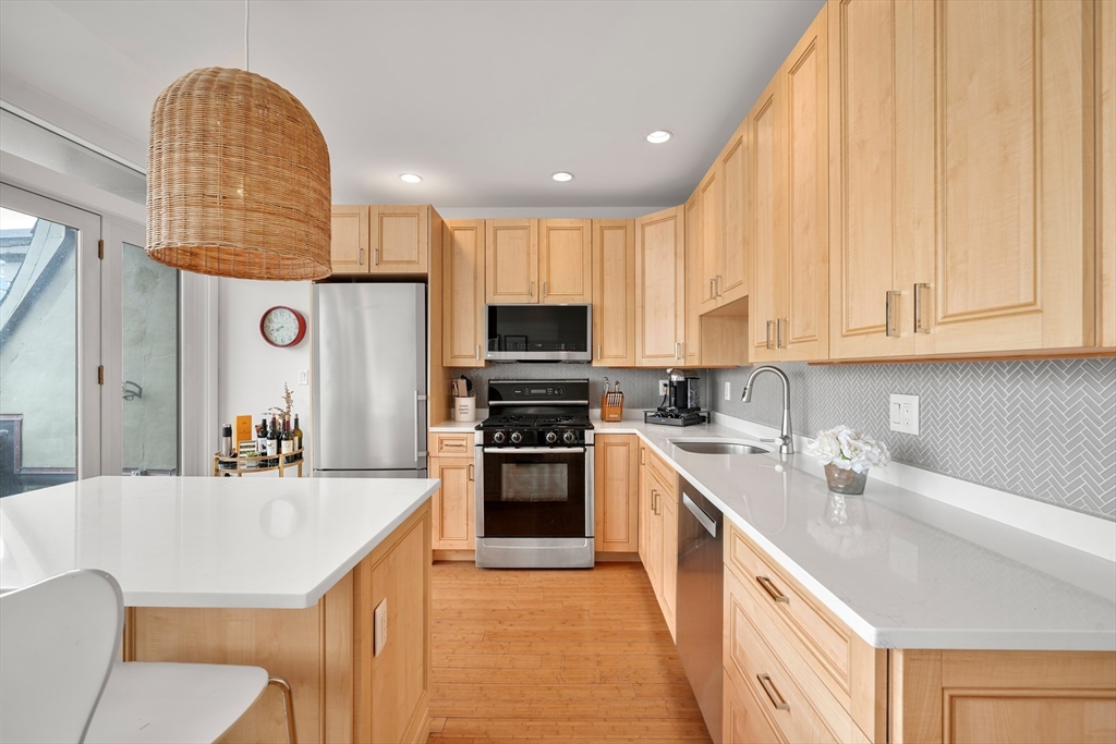 21 Worcester Square, Unit 5 Boston, MA 02118 - Photo 4 of 33 a kitchen with a sink a counter top space stainless steel appliances and cabinets