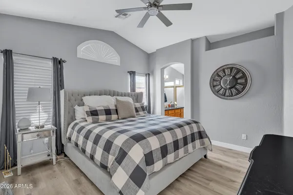 a bedroom with a bed and a chandelier
