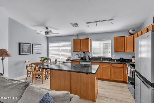 a kitchen with granite countertop a sink stove and cabinets