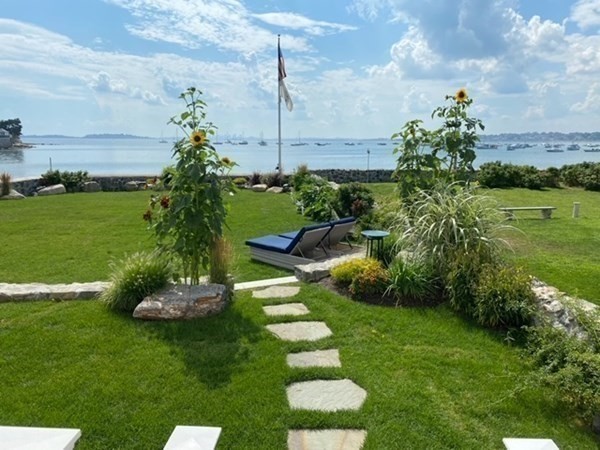 75 Puritan Road, Unit 1 Swampscott, MA 01907 - Photo 1 of 17 a view of a garden with a fountain