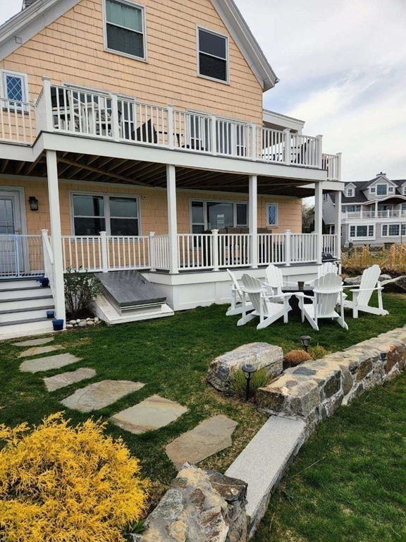 75 Puritan Road, Unit 1 Swampscott, MA 01907 - Photo 13 of 17 a front view of a house with a yard