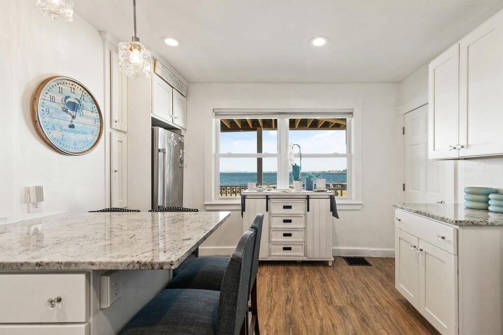 75 Puritan Road, Unit 1 Swampscott, MA 01907 - Photo 3 of 17 a large white kitchen with a large window