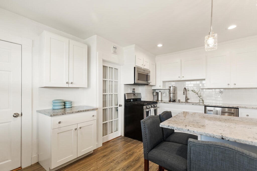 75 Puritan Road, Unit 1 Swampscott, MA 01907 - Photo 4 of 17 a kitchen with white cabinets and stainless steel appliances