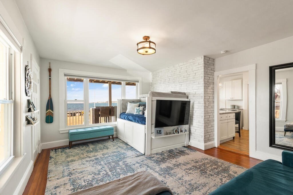 75 Puritan Road, Unit 1 Swampscott, MA 01907 - Photo 6 of 17 a living room with a flat screen tv and a rug