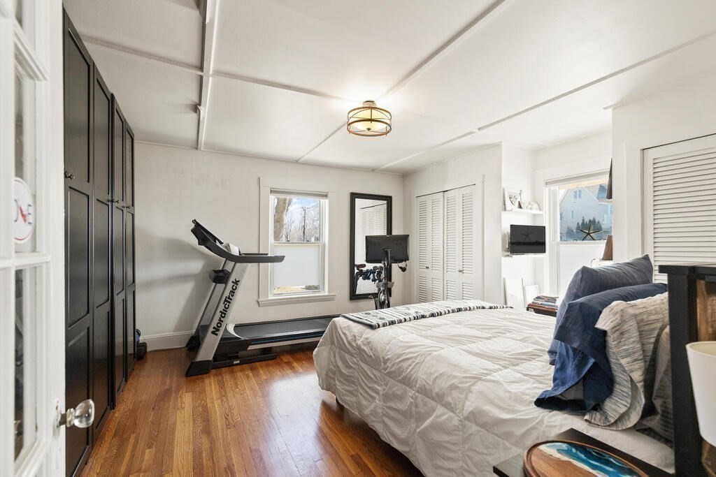 75 Puritan Road, Unit 1 Swampscott, MA 01907 - Photo 8 of 17 a bedroom with a bed and wooden floor