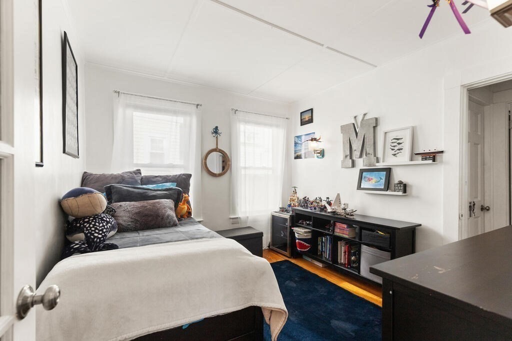 75 Puritan Road, Unit 1 Swampscott, MA 01907 - Photo 10 of 17 a bedroom with a bed and wooden floor