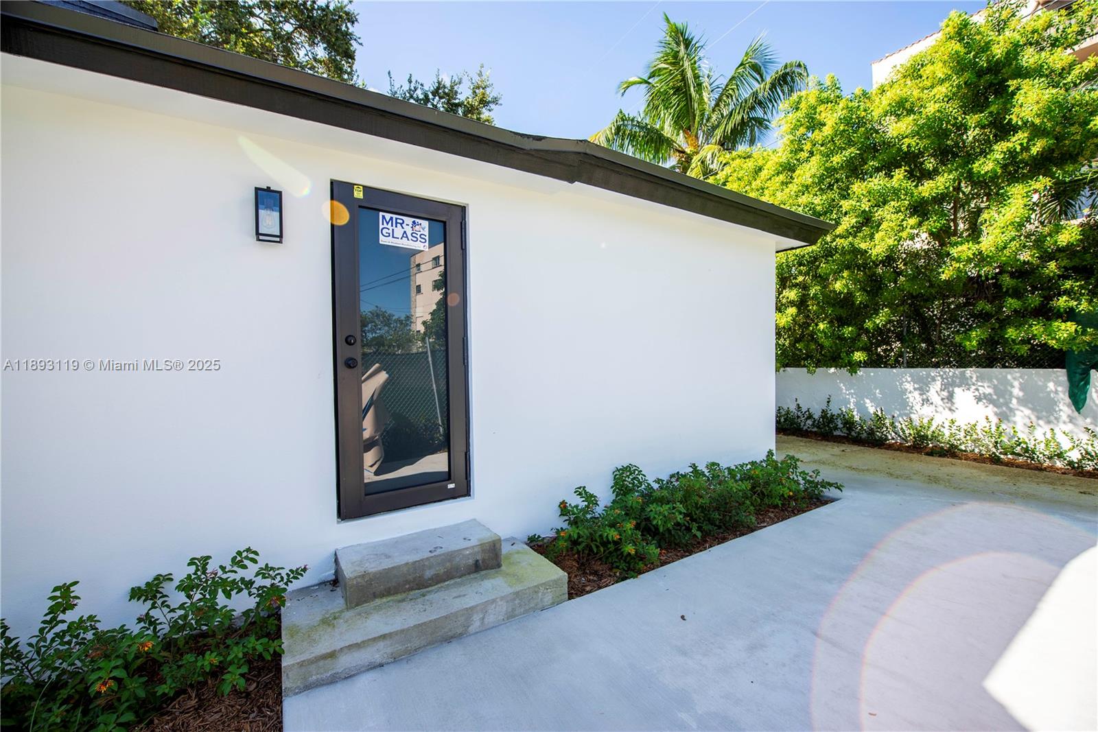 764 Northwest 36th Avenue, Unit 2 Miami, FL 33125 - Photo 10 of 11 a front view of a house with garden