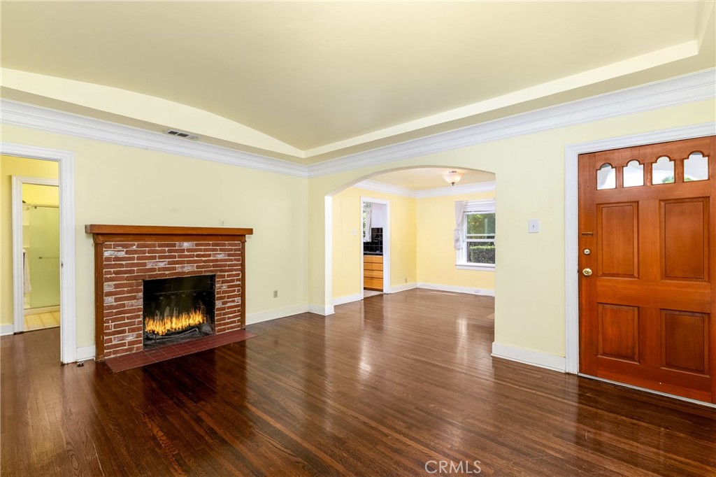 9959 Garibaldi Avenue Arcadia, CA 91007 - Photo 11 of 51 a view of an empty room with wooden floor fireplace and a window