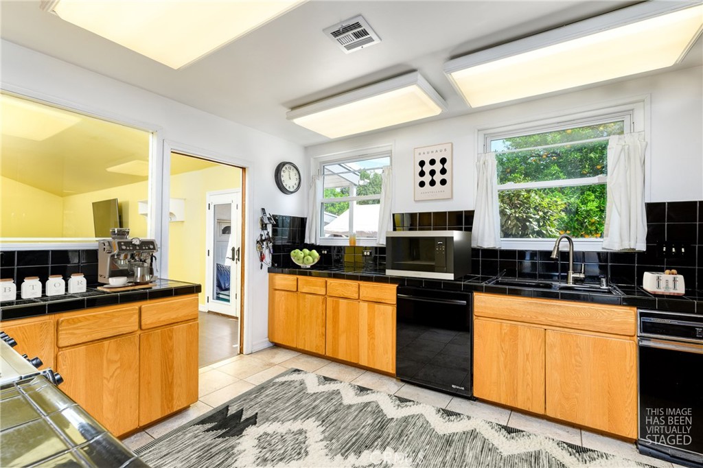 9959 Garibaldi Avenue Arcadia, CA 91007 - Photo 15 of 51 a kitchen with granite countertop a sink cabinets and stainless steel appliances