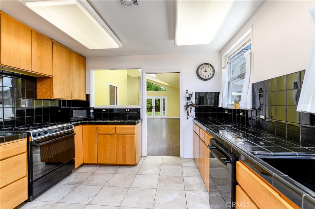 9959 Garibaldi Avenue Arcadia, CA 91007 - Photo 17 of 51 a kitchen with stainless steel appliances granite countertop a stove a sink and a microwave