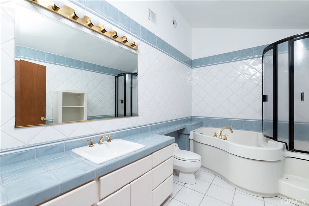 9959 Garibaldi Avenue Arcadia, CA 91007 - Photo 38 of 51 a bathroom with a granite countertop sink mirror vanity and toilet