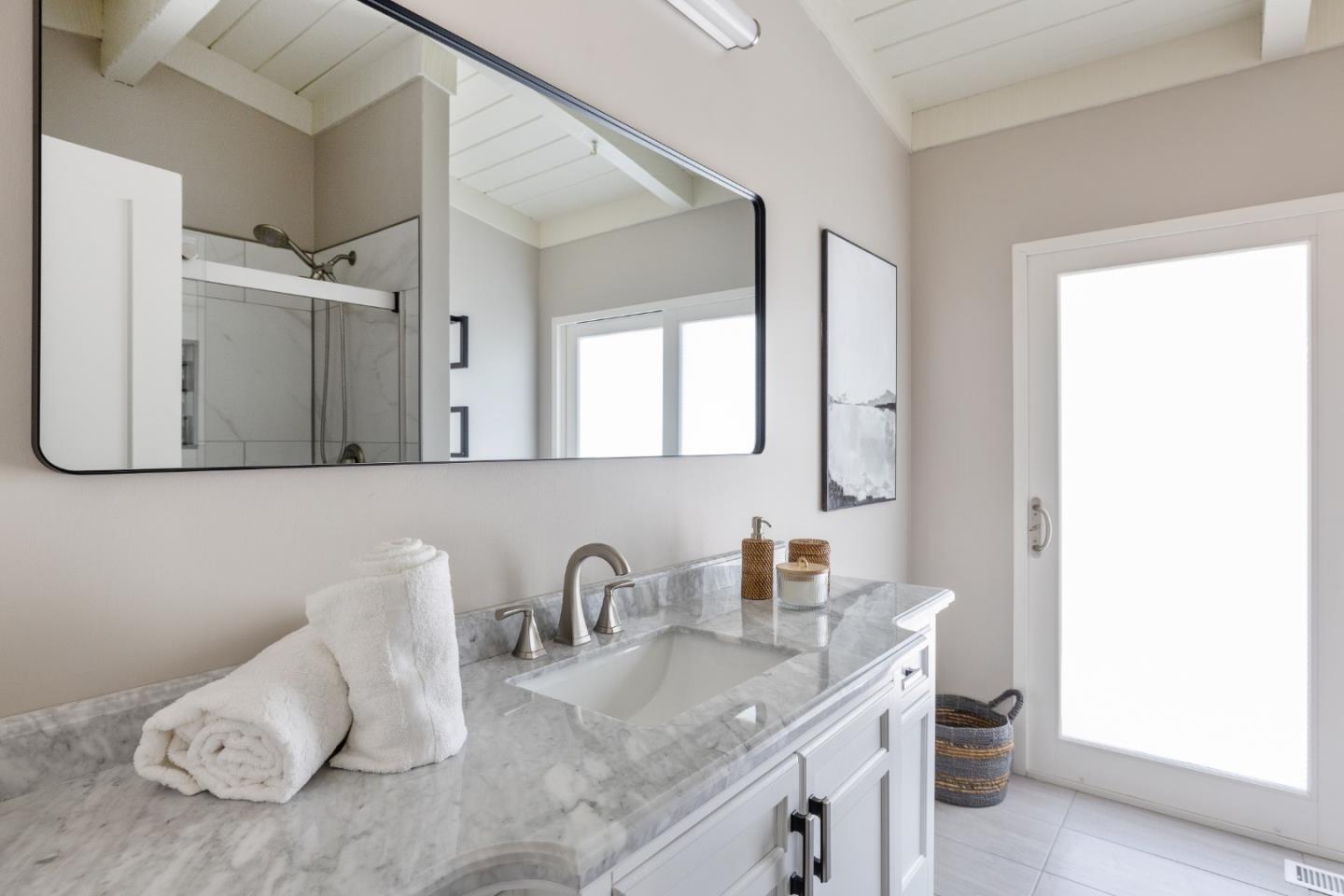 25165 Stewart Place Carmel, CA 93923 - Photo 25 of 51 a bathroom with a granite countertop sink and a mirror