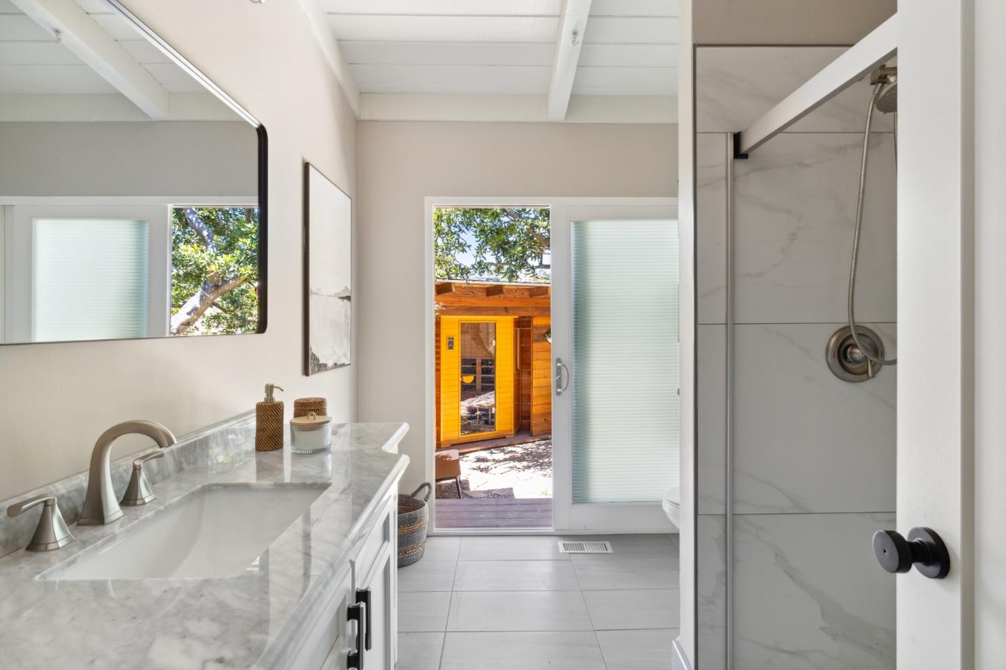 25165 Stewart Place Carmel, CA 93923 - Photo 28 of 51 a bathroom with a granite countertop shower a sink and a window